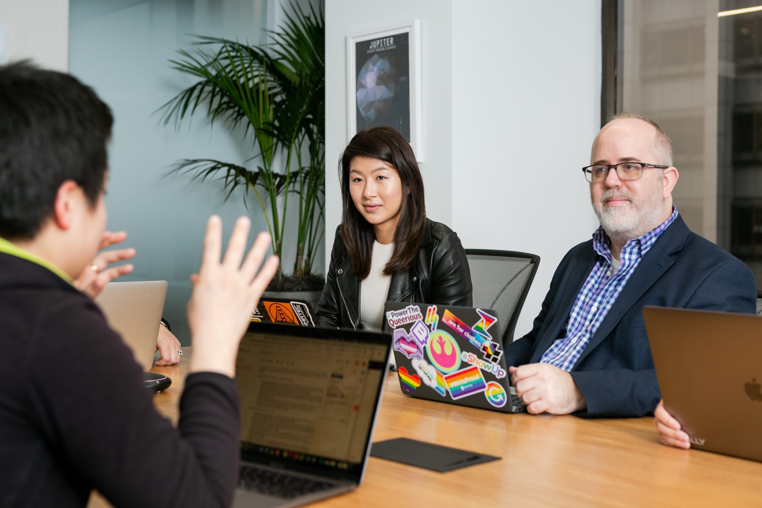 Photo of people working at a desk in a meeting