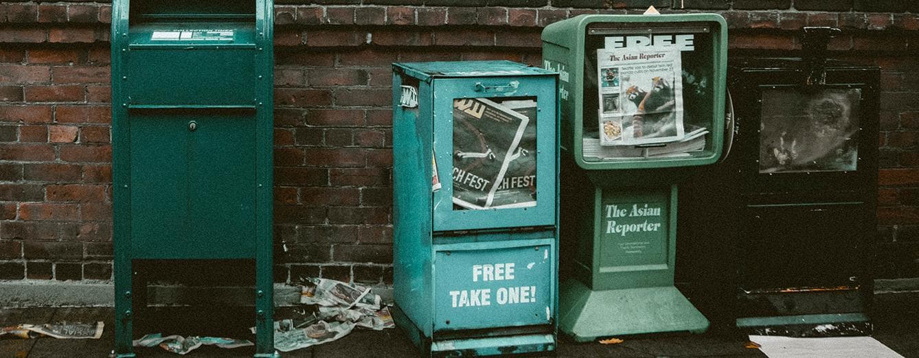 Article Cover : run down looking vending machines for newspapers