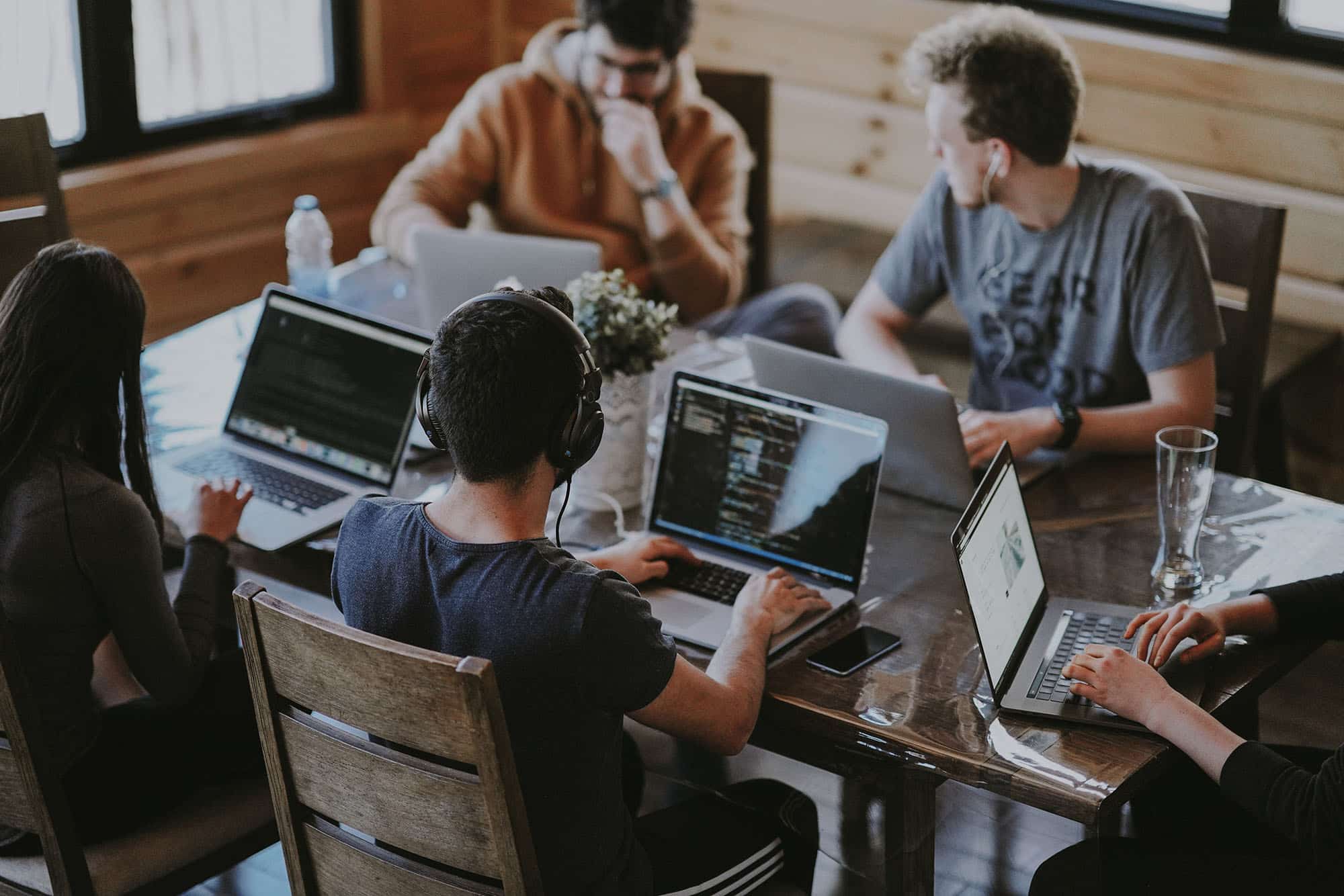 photo of a team using laptops at a desk